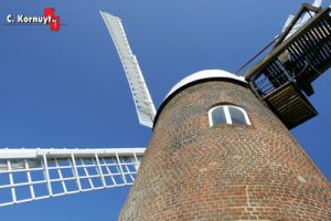 Old windmill against blue sky background